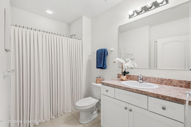 bathroom featuring vanity, toilet, and tile patterned floors