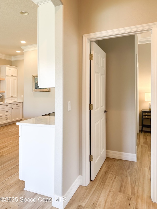 hall featuring crown molding and light wood-type flooring