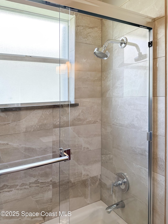 bathroom featuring shower / bath combination with glass door