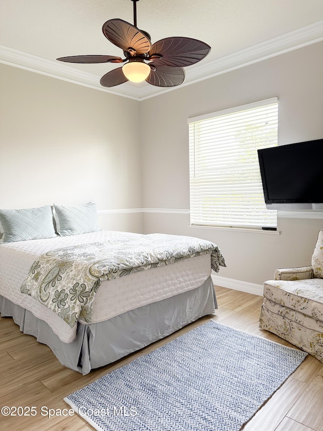 bedroom with crown molding, ceiling fan, and light wood-type flooring