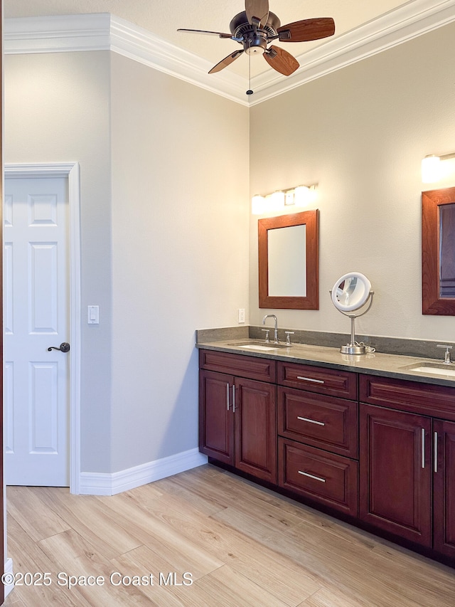 bathroom with vanity, crown molding, wood-type flooring, and ceiling fan