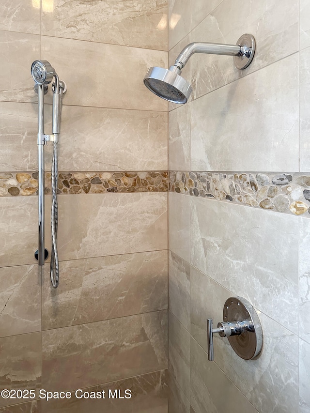 bathroom with tiled shower