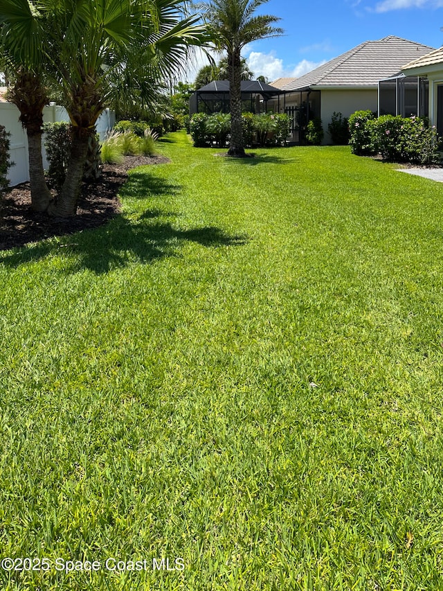 view of yard with a lanai