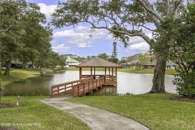 dock area featuring a gazebo, a lawn, and a water view