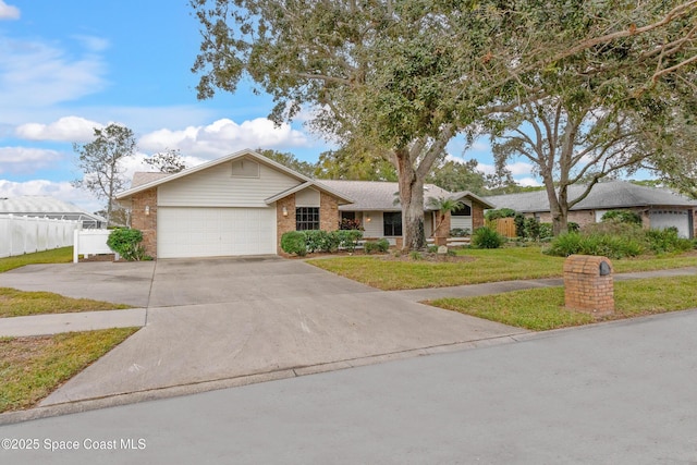 single story home with a garage and a front lawn