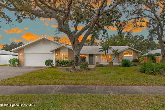 single story home with a yard and a garage