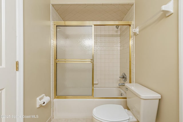 bathroom with enclosed tub / shower combo and toilet