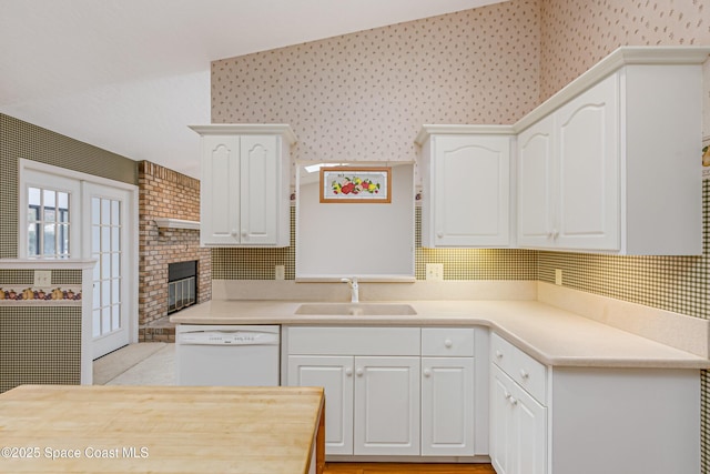 kitchen featuring white cabinetry, dishwasher, and sink