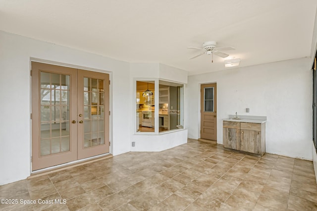 interior space with sink, french doors, and ceiling fan