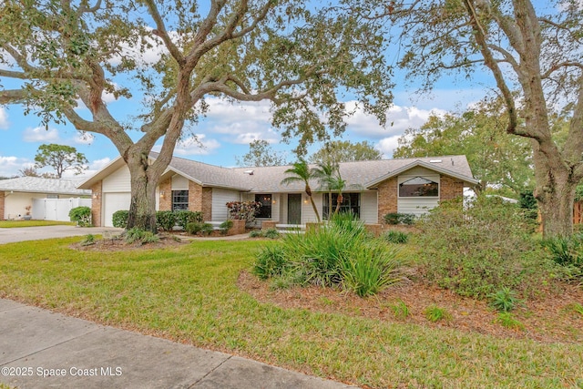 single story home featuring a front yard and a garage