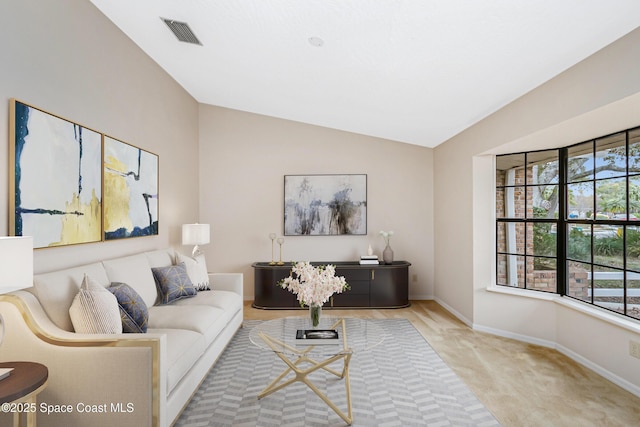 carpeted living room featuring a wealth of natural light and vaulted ceiling