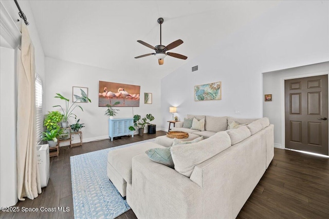 living room featuring radiator heating unit, dark hardwood / wood-style floors, vaulted ceiling, and ceiling fan