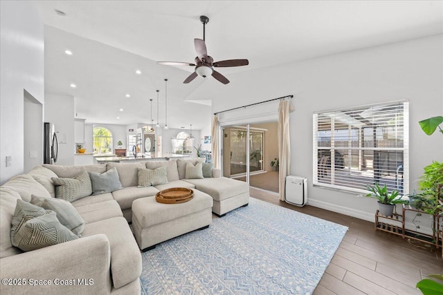 living room with wood-type flooring, ceiling fan, and sink