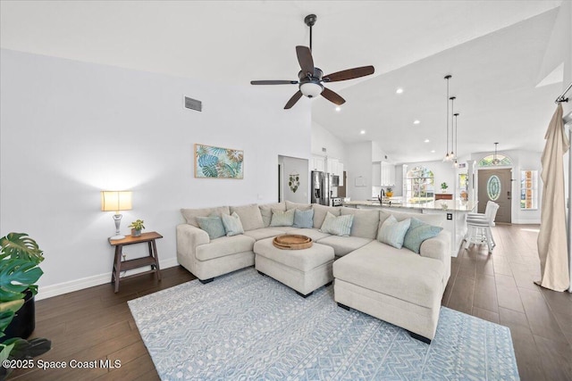 living room featuring high vaulted ceiling, ceiling fan, dark wood-type flooring, and sink