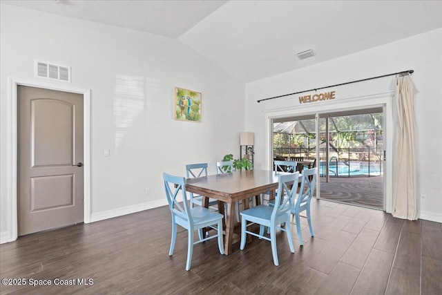 dining area featuring vaulted ceiling