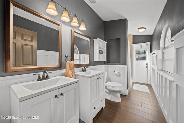 bathroom with vanity, hardwood / wood-style flooring, toilet, and vaulted ceiling