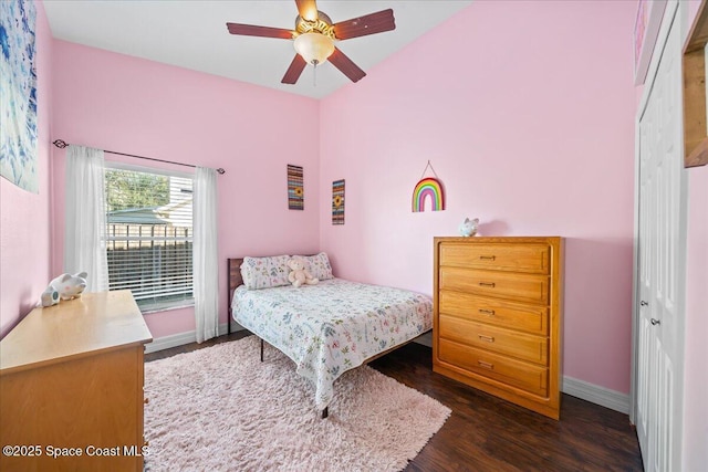 bedroom featuring ceiling fan, a closet, and dark wood-type flooring