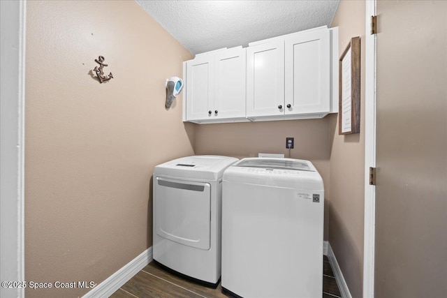 laundry area featuring cabinets, independent washer and dryer, and a textured ceiling