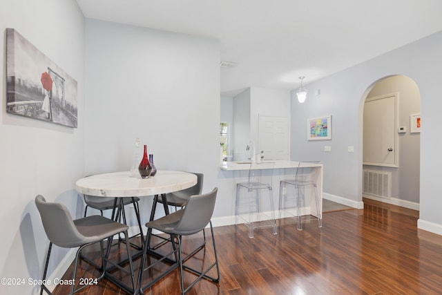 dining area with dark hardwood / wood-style flooring and sink