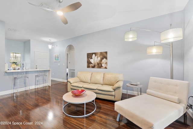 living room with dark hardwood / wood-style flooring, ceiling fan, and sink