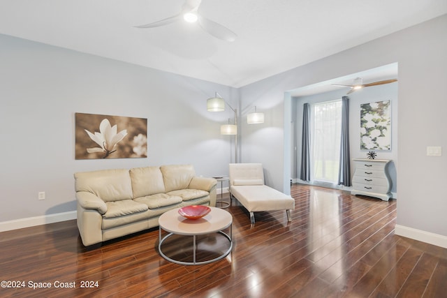 living room with ceiling fan and dark hardwood / wood-style flooring