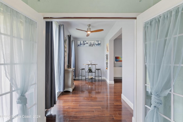 corridor with dark hardwood / wood-style flooring