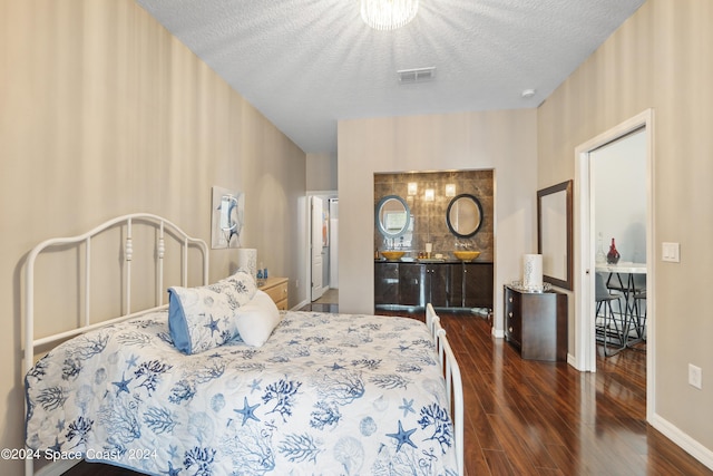 bedroom with dark hardwood / wood-style flooring and a textured ceiling