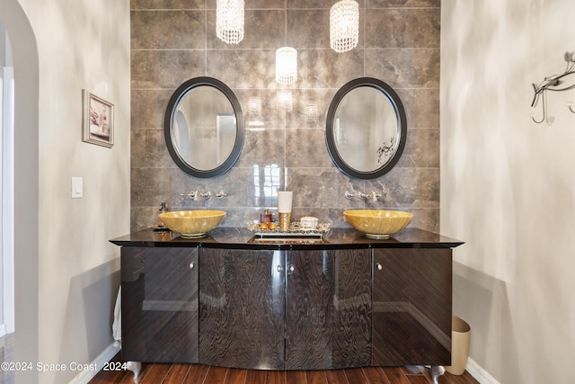 bathroom with vanity, backsplash, and hardwood / wood-style flooring