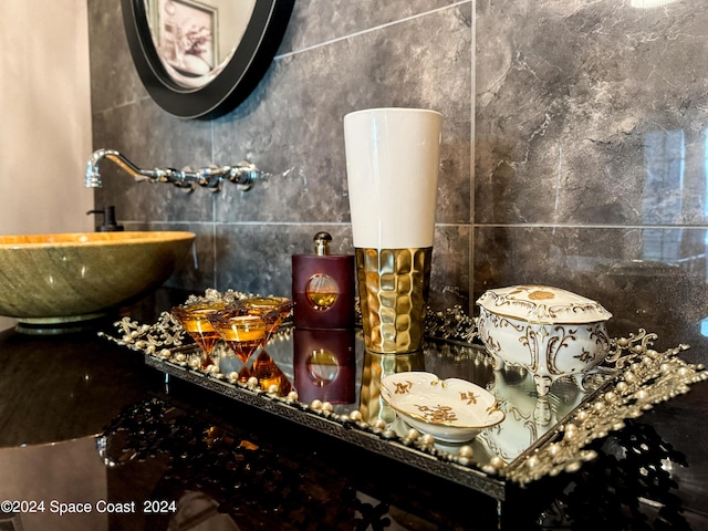 bathroom featuring sink and tile walls