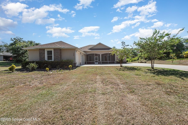 ranch-style house with a sunroom and a front lawn