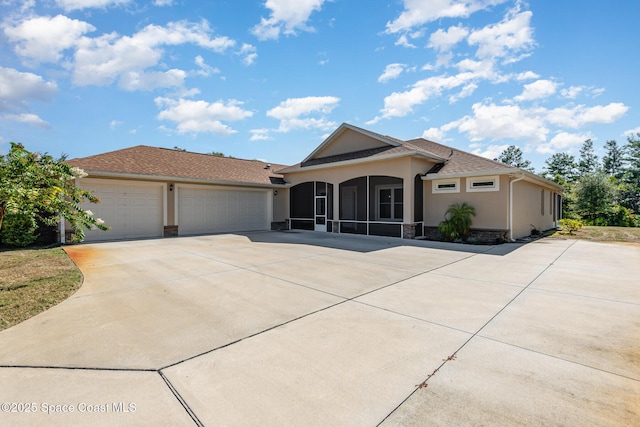 single story home featuring a garage and a sunroom