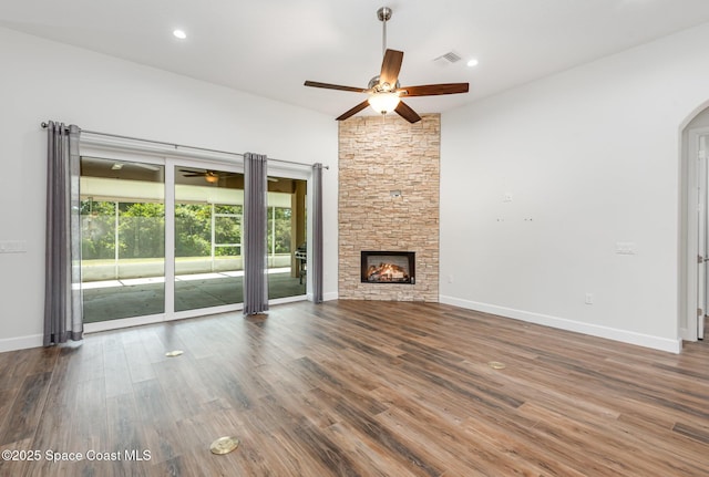 unfurnished living room featuring a fireplace, dark hardwood / wood-style floors, and vaulted ceiling