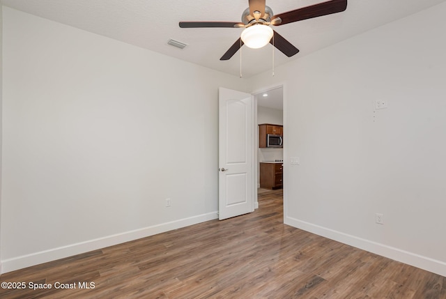 unfurnished room featuring hardwood / wood-style flooring and ceiling fan