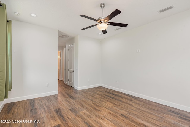 empty room with ceiling fan and dark wood-type flooring