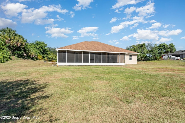 back of property featuring a sunroom and a yard