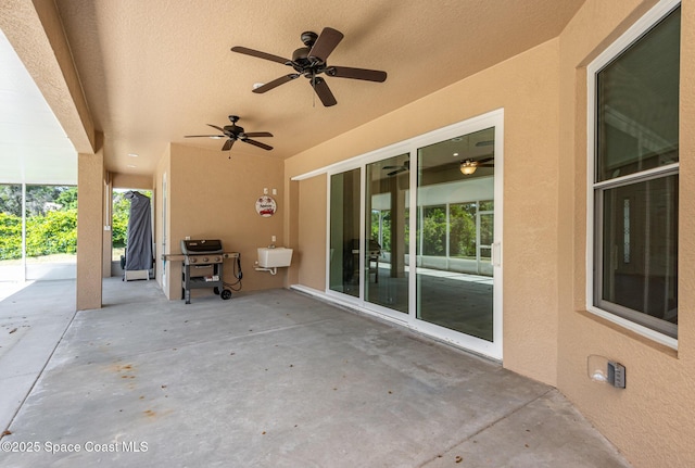 view of patio / terrace with ceiling fan and a grill