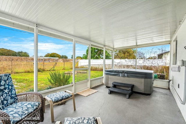 sunroom with a hot tub