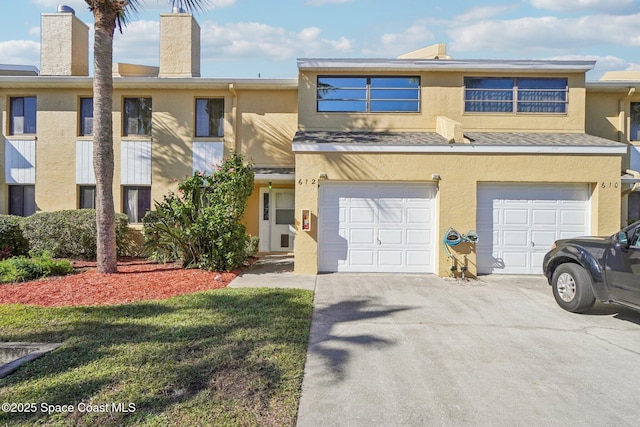 townhome / multi-family property featuring a garage