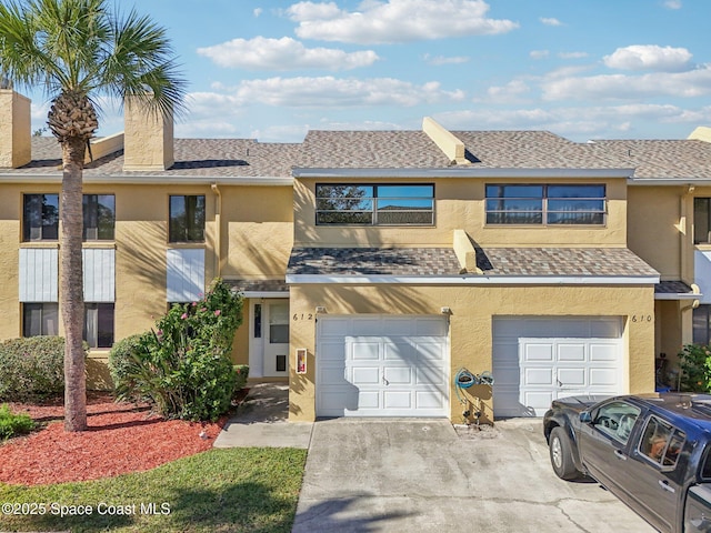 multi unit property featuring a garage