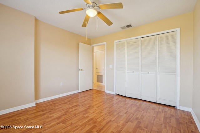 unfurnished bedroom with ceiling fan, light hardwood / wood-style flooring, and a closet