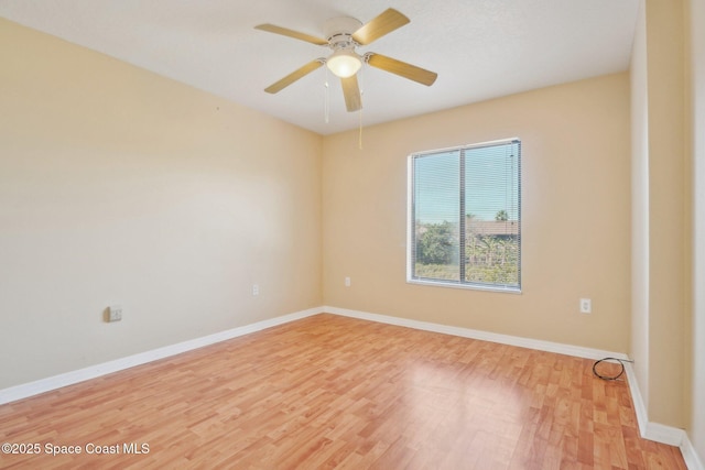 unfurnished room with ceiling fan and hardwood / wood-style flooring