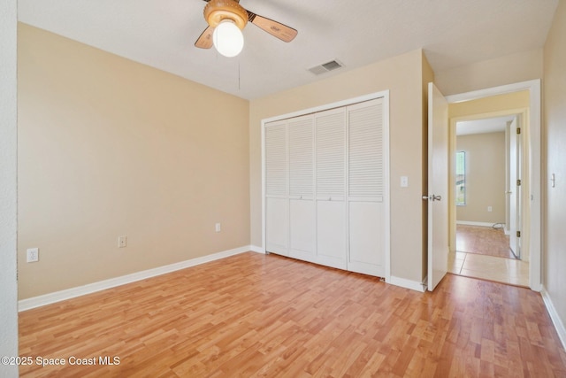 unfurnished bedroom featuring a closet, ceiling fan, and light hardwood / wood-style floors