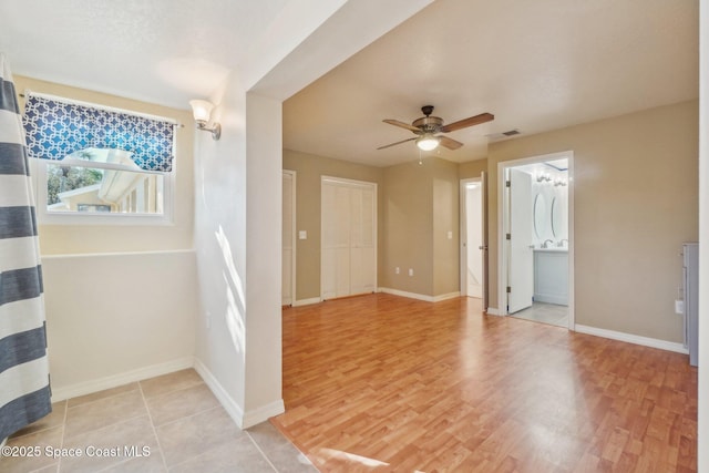 unfurnished room featuring ceiling fan and light hardwood / wood-style flooring