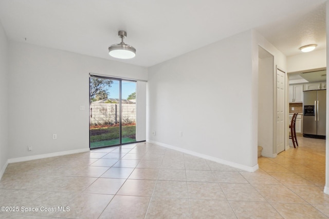 spare room featuring light tile patterned flooring