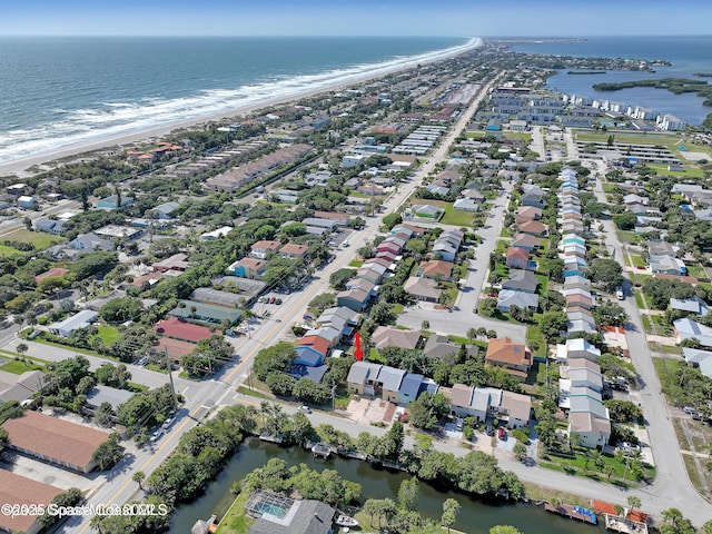 drone / aerial view with a beach view and a water view