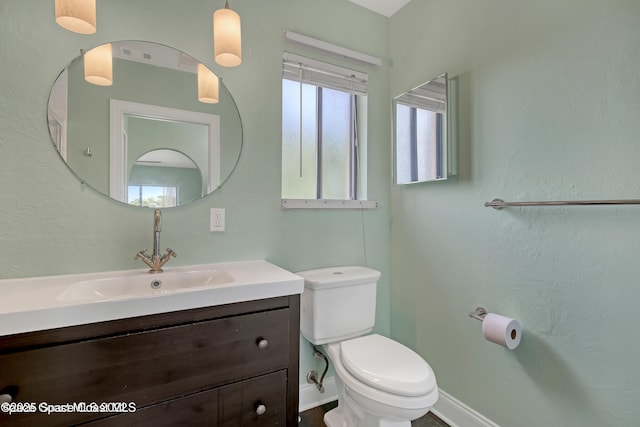 bathroom featuring toilet and vanity