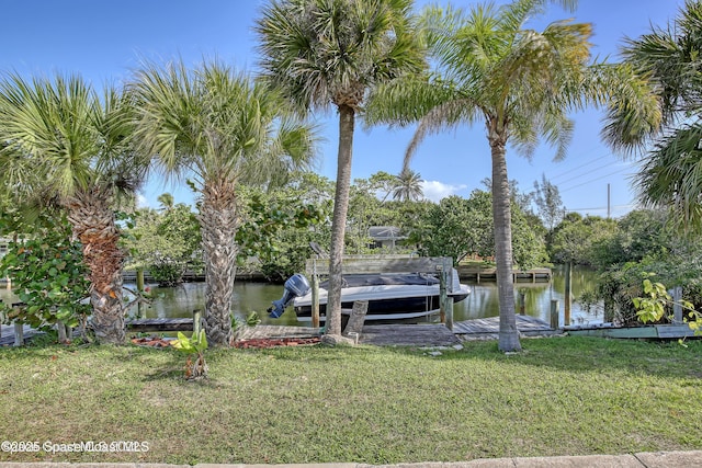 dock area featuring a lawn and a water view