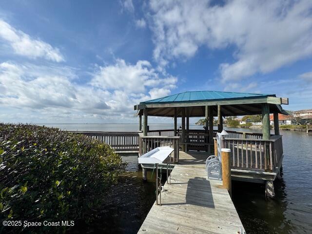 dock area with a gazebo and a water view