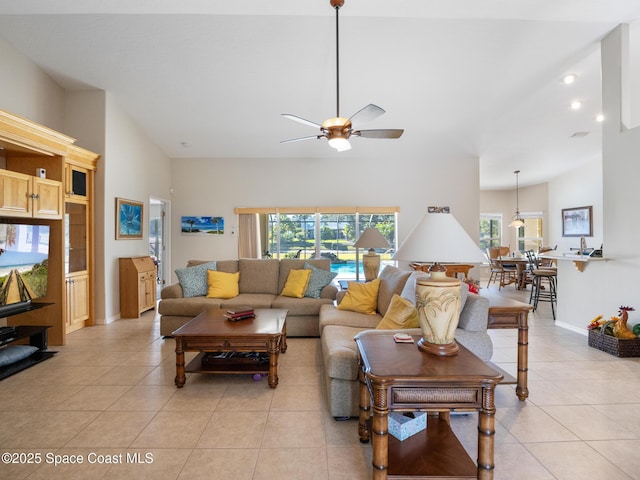 tiled living room featuring ceiling fan and vaulted ceiling