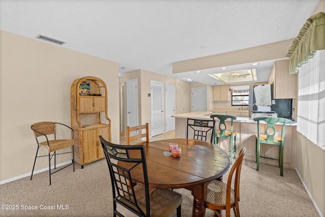 carpeted dining room featuring sink